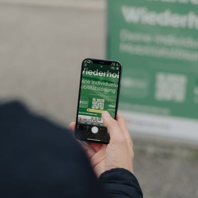 Mann hält Smartphone und Scannt Qr-Code